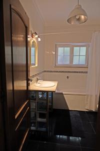 a bathroom with a sink and a bath tub at FreeSurfCamp & Hostel in Peniche