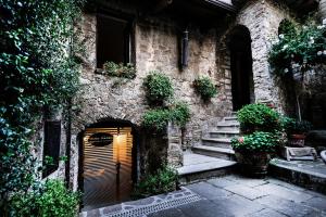 an old stone building with a wooden door and stairs at Antico Convento - Ospitalità Diffusa in Rocca Cilento