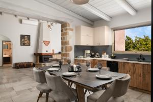 a kitchen and dining room with a table and chairs at Mansion D in Galatás