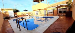 a swimming pool in front of a house at Villa Flor de Loto in Palazuelos