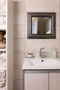 a bathroom with a sink and a mirror and towels at Sea view Carmel Mountain University in Haifa