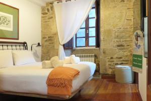 A bed or beds in a room at Sete Artes by Como en Casa