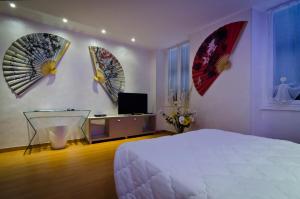 a bedroom with a bed and four mirrors on the wall at Via Palazzo Sanremo in Sanremo