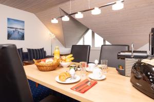 a wooden table with a basket of fruit on it at Apart Holidays in Morschach