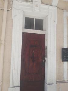 a wooden door in a building with a window at studio terrasse in Toulon