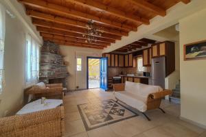 a living room with a couch and a table at Monolithos Villas in Kipri