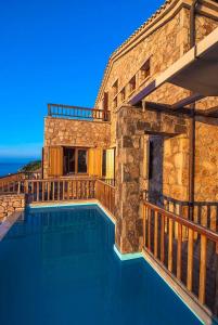 a house with a swimming pool next to a building at Beyond Villas in Agios Nikitas