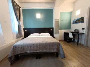 Postel nebo postele na pokoji v ubytování Il B&B di PIAZZA MOTTA