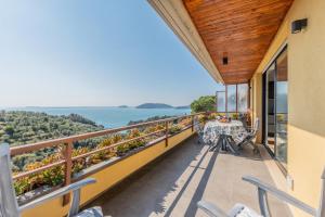 a balcony with a table and chairs and a view of the ocean at Eco del Silenzio in Lerici