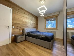 A bed or beds in a room at 021 Attico Quadrilocale, Pinzolo