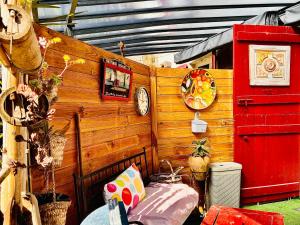 a room with a bed and a wooden wall at Studio le moulin de Pascale in Espelette