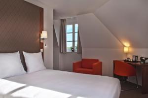 Un pat sau paturi într-o cameră la Domaine de Frémigny