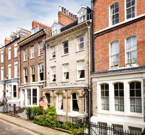 a row of brick buildings on a street at 23 St Mary's in York