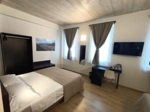 Postel nebo postele na pokoji v ubytování Il B&B di PIAZZA MOTTA