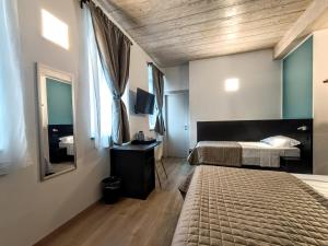 Postel nebo postele na pokoji v ubytování Il B&B di PIAZZA MOTTA