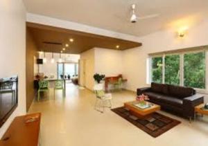 a living room with a couch and a table at SWISS COUNTY in Idukki