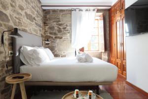A bed or beds in a room at Sete Artes by Como en Casa