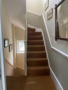 a staircase in a home with a stair case at Comfortable 2 Bedroom Apartment in Lavish Holland Park with Balcony in London