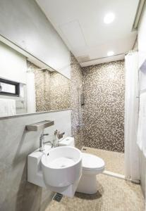 a bathroom with a white toilet and a sink at 在家行旅 中山館 in Taipei