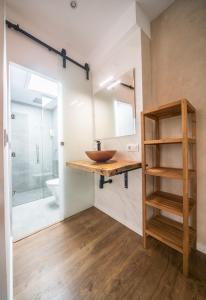 a bathroom with a wooden sink and a toilet at REY DE SEVILLA FLATS - Duplex Museo in Seville