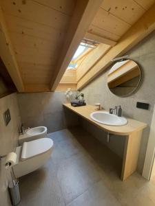 a bathroom with a toilet and a sink at B&B La Casa del Sole in Ziano di Fiemme
