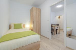 a bedroom with a bed and a dining room at OLD TOWN Apartments in Ljubljana