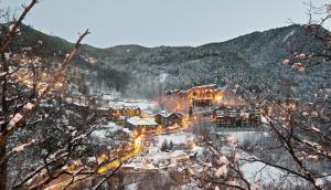a town covered in snow with a mountain at Aparthotel AnyosPark Mountain & Wellness Resort in Anyós
