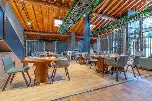 a dining room with wooden tables and chairs at Aparthotel AnyosPark Mountain & Wellness Resort in Anyós