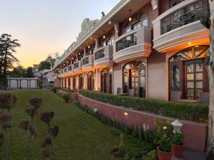 an exterior view of a building with a yard at Ramada by Wyndham Mussoorie Mall Road in Mussoorie