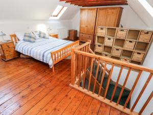 a bedroom with a bed and a wooden floor at Rock House in Haverfordwest
