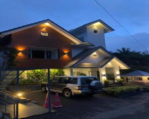 a jeep parked in front of a house at night at SWISS COUNTY in Idukki