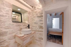 a bathroom with a sink and a mirror at Blue Vorna in Ano Syros