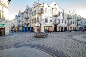 a cobblestone street in a city with buildings at Przy Deptaku in Nowy Sącz