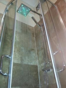a shower with a glass door in a bathroom at Two Top Central Unique Artisan Beach Studios - also separate spa cabin in Brighton & Hove