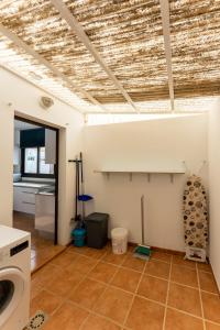 a laundry room with a washer and dryer on the ceiling at villa del mar puerto del carmen in Puerto del Carmen