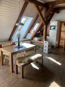 a kitchen and dining room with a table and chairs at Farma Klokočov in Vítkov