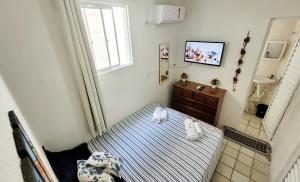 um pequeno quarto com uma cama e uma casa de banho em Porto Paraiso Hostel em Porto de Galinhas