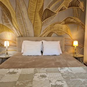 a bedroom with a bed with two pillows at Salvacintoggio -Votre Villa avec Piscine Privée- in Porto-Vecchio