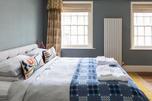 a bedroom with a bed with a blanket on it at Severnside Press BnB in Newnham