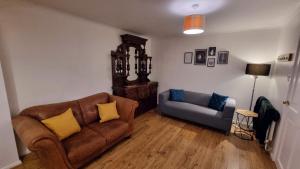 a living room with a couch and a chair at Stockwood House by Cliftonvalley Apartments in Bristol