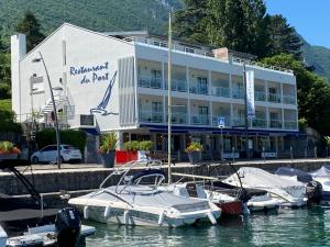 a building with boats in the water in front of a marina at CAMP DE BASE SUR LE LAC DU BOURGET in Le Bourget-du-Lac +8 photos
