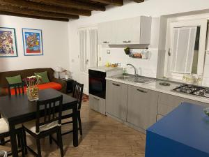 a kitchen and living room with a table and a couch at Appartamenti Vittorio Emanuele in Palermo