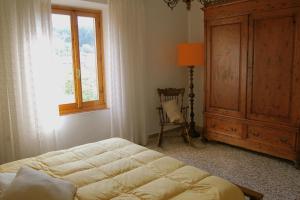 a bedroom with a bed and a window and a dresser at Casa Martellina - Holiday Home in Bagno a Ripoli