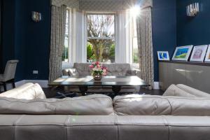 a living room with a couch and a table at Applewood Hotel in Bournemouth