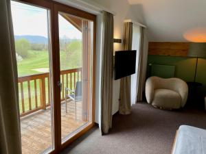 a room with a balcony with a sliding glass door at Sapia Hotel Rheinsberg in Bad Säckingen