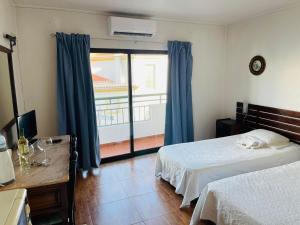 a bedroom with a bed and a large window at Casa do Canto in Albufeira +214 photos