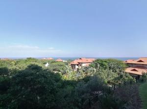 a group of houses on a hill with trees at Zimbali 2007 in Ballito