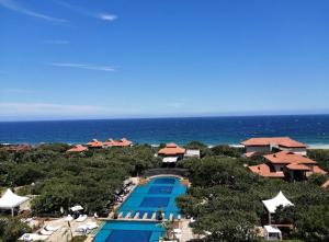 an aerial view of a resort with a pool and the ocean at Zimbali 2007 in Ballito