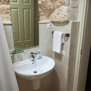 a bathroom with a white sink and a mirror at Trulli Manuela 2 in Locorotondo +64 photos
