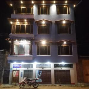 a motorcycle parked in front of a building at night at Rosa Victoria in Tarapoto